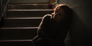 sad woman sitting in the dark