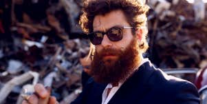 masculine guy with sunglasses and beard smoking cigar