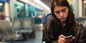 woman looking forlorn on phone