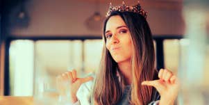 bossy woman wearing a crown and pointing at herself