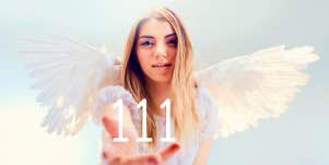 angel holding the number 111 in her hand