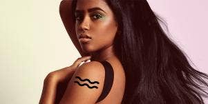 woman with aquarius tattoo on her arm