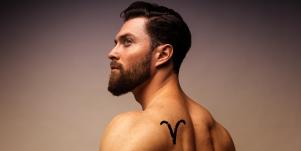 man with aries tattoo on shoulder