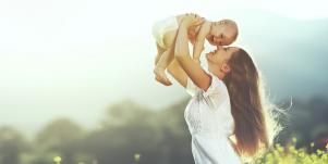 woman kissing baby