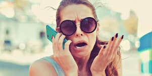 exasperated woman holding a phone