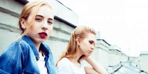 Young blonde women on a rooftop looking moody