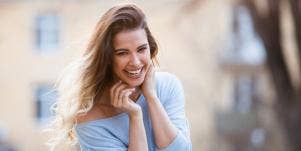 woman with chin in hands smiling
