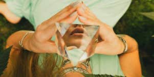 woman holding clear crystal