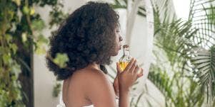 woman holding a bottle of essential oil