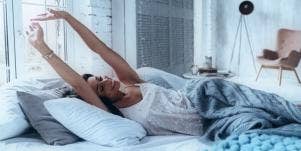 woman stretching in bed
