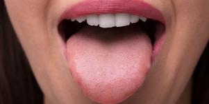 closeup of woman's mouth with her tongue out