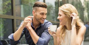 man using body language to show his interest in woman drinking cup of coffee