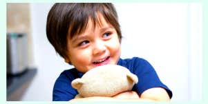 Boy cuddling a toy