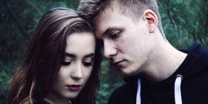 woman and man looking emo and touching foreheads