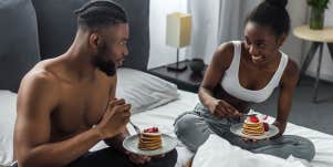 couple having pancakes in bed