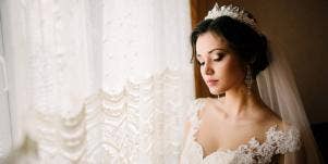 bride posing in front of window