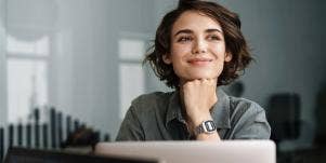 successful woman smiles while she completes her work efficiently