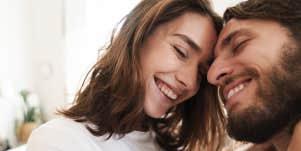 man and woman nuzzling foreheads