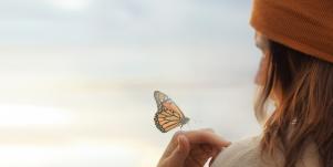 woman with butterfly on hand