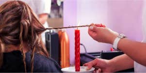 woman getting candle cutting done