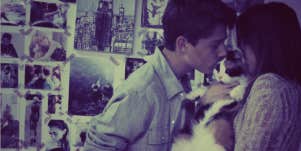 couple kissing cat