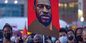 protestors await chauvin verdict, carrying a painting of george floyd