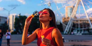 young girl blowing bubbles