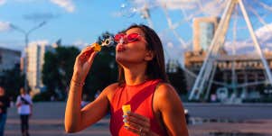 young girl blowing bubbles