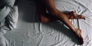 woman's legs on a bed