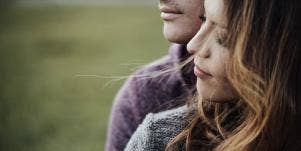 couple gazing together background of grass