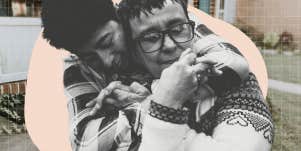 Lesbian couple embracing on the porch of their home