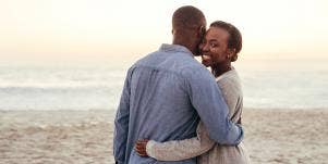 man and woman embracing on beach