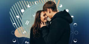 couple in front of astrology wheel