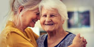 woman hugging an elderly female 