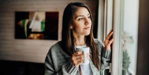 woman gazing out the window in contemplation 