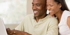 happy couple sharing computer