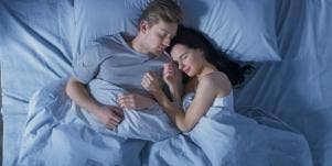 happy couple in bed sleeping