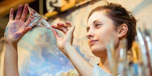 Glass artist observes her work