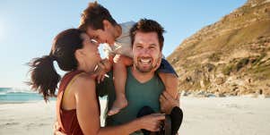 family on beach posing for photo