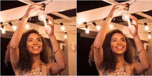 happy woman fixing a lightbulb