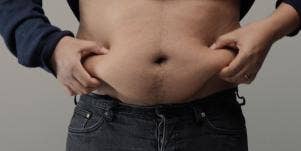 man holding belly fat