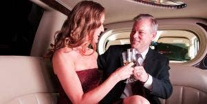 woman and man in limo together clinking champagne glasses