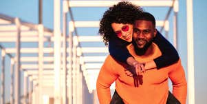 man carrying woman on his back