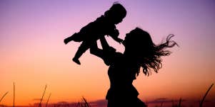 mom throwing baby in air