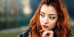 girl with red hair thinking