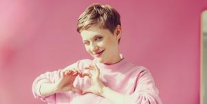 woman making a heart shape with her hands