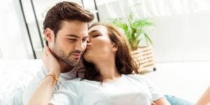 woman kissing man's ear