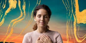 woman meditating in front of a sunset and gold decor