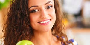 Woman holding a green apple