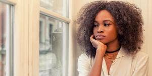 sad woman looking out the window